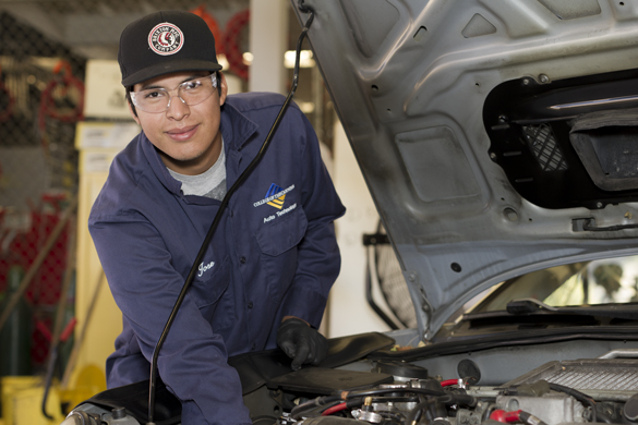 Auto mechanic student under the hood.