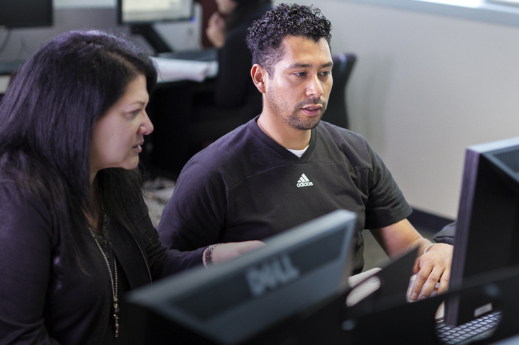 Faculty working with Computer Applications student. 