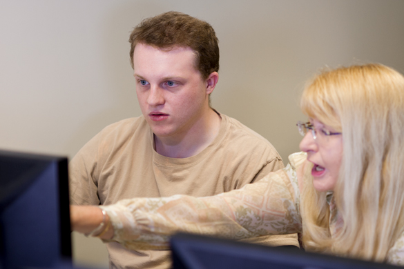 Computer Applications student with instructor at computer. 