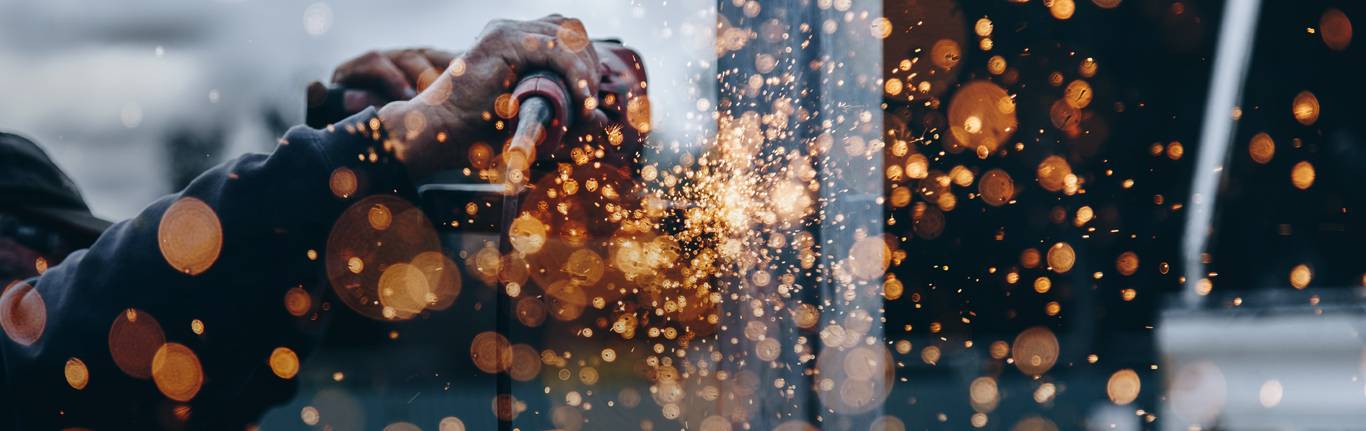 Construction worker using a grinder.