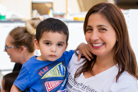 College of the Canyons Valencia Campus. Faculty member holding child. 