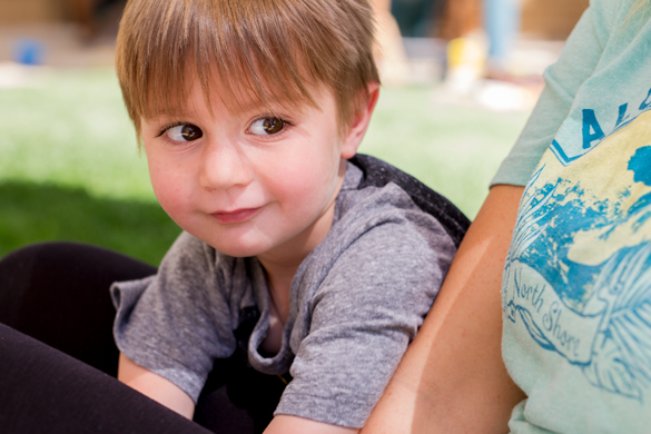 College of the Canyons Valencia Campus. Faculty member sitting with child. 