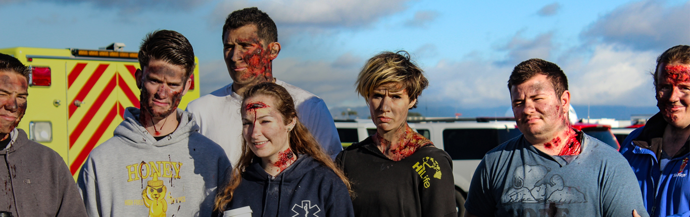 EMT students practicing an injury scene.