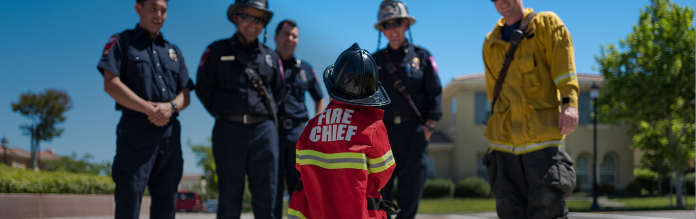 Fire Fighters smiling and talking to young future "Fire Chief".