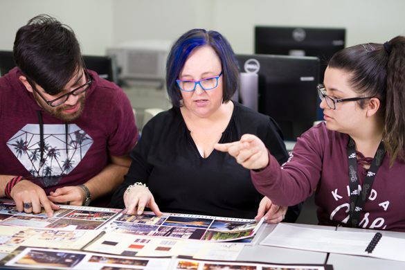 Interior Design instructor working with students on portfolio. 