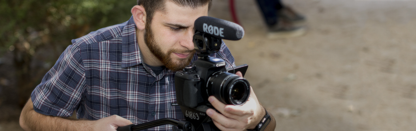 MEA Filmmaking student filming with camera. 