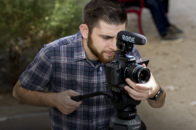 MEA Filmmaking student filming with camera. 