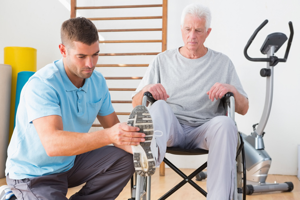 Physical Therapist assisting a wheelchair client.