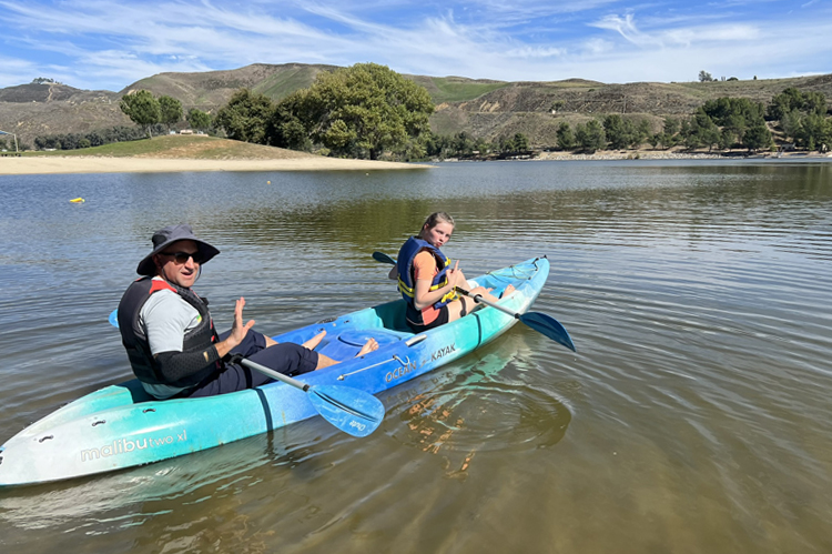 Students kayaking on a lake.