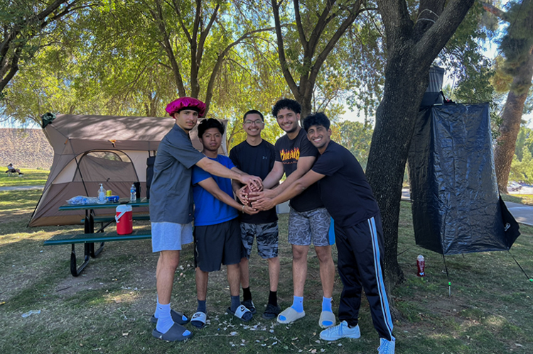 Students linking hands.