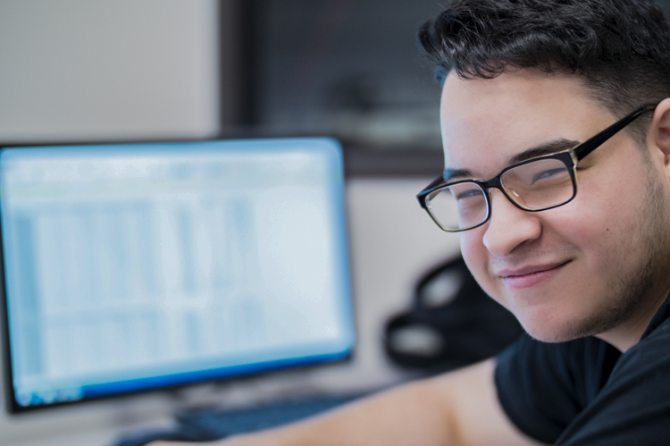 COC Computer Networking student at computer. 