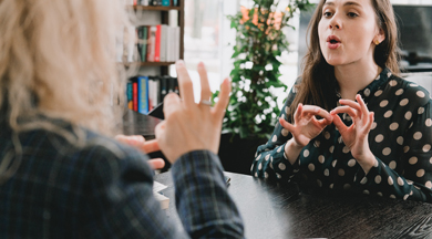 Teaching young lady sign language.