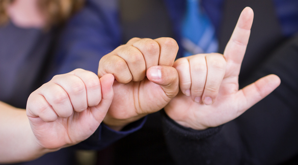 Students using sign language. 