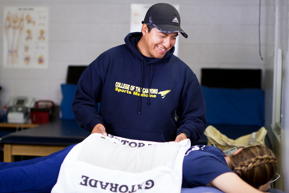 Sports Medicine student getting heat blanket physical therapy. 