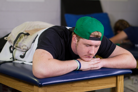 Sports Medicine student getting heat blanket physical therapy. 