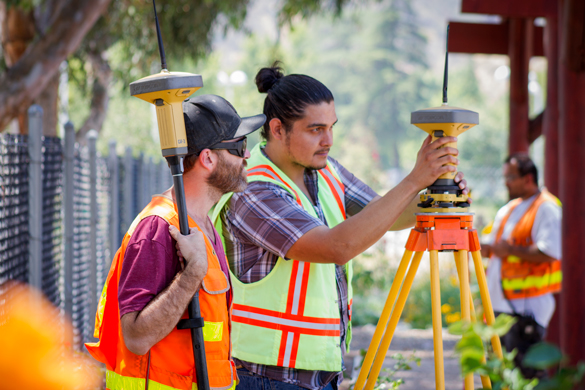 Members of CRC's team work on the Community Gardens' land surveying project. 