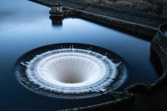 The overflow plughole on Ladybower reservoir in full flow. Peak District, England.