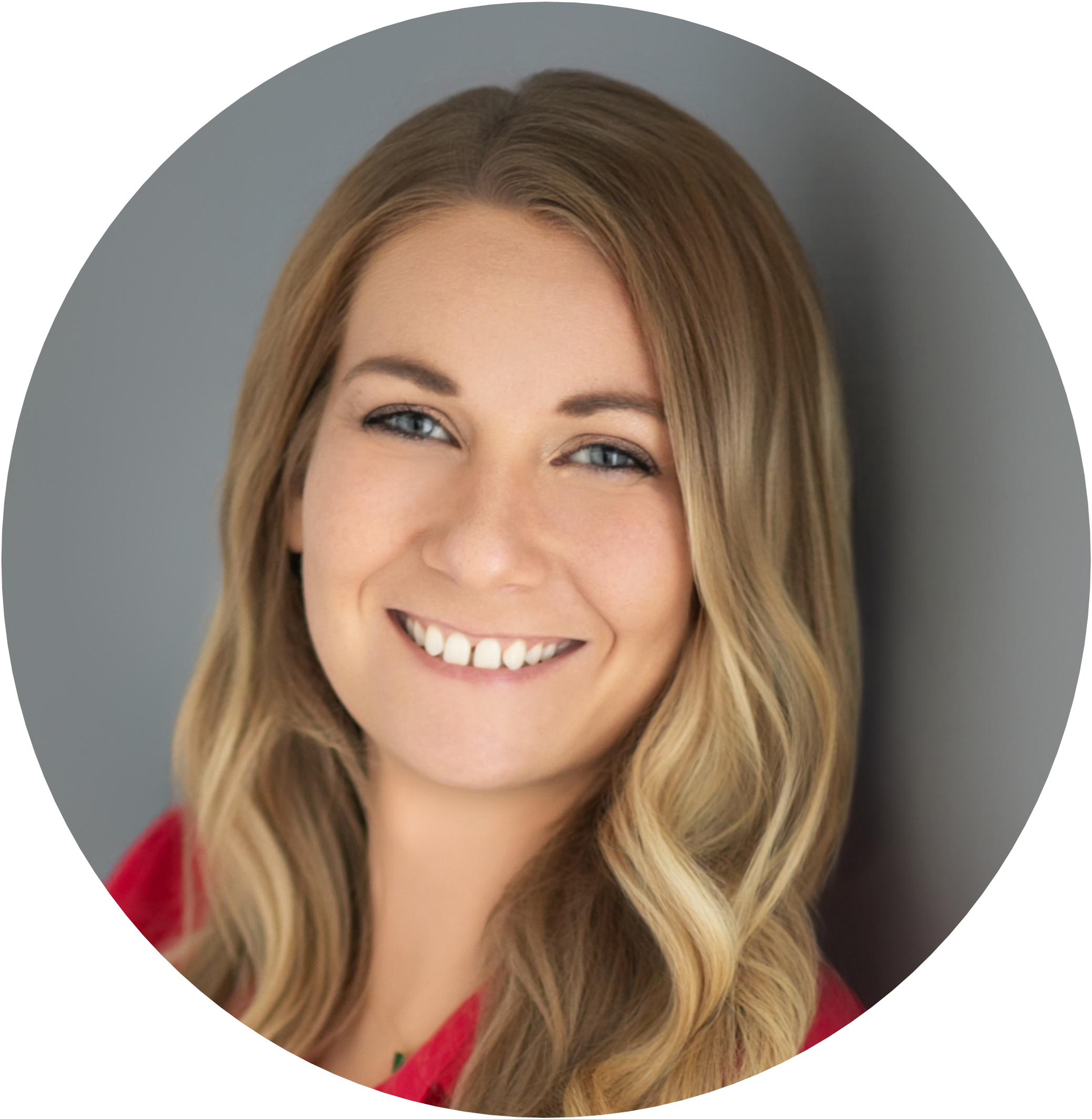 Professional headshot of a smiling woman with long, wavy hair.