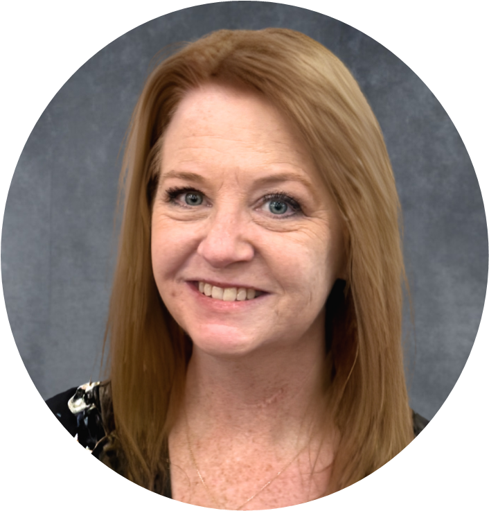 Professional headshot of a woman with long, blonde hair, smiling against a grey background.