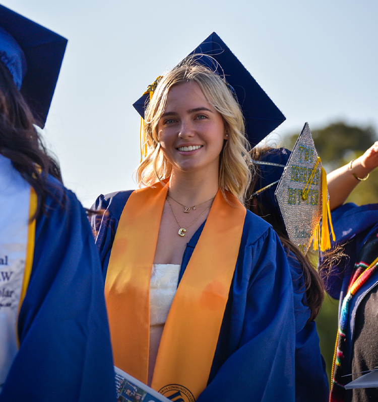 Students in caps and gowns participate in commencement.