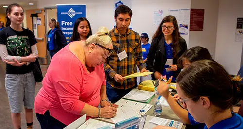VITA volunteers prepare a tax return for a community member.