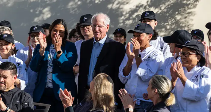 Culinary arts faculty and students applaud Gary Cusumano (center) for his $1 million gift honoring the life and legacy of educator Diana Cusumano.