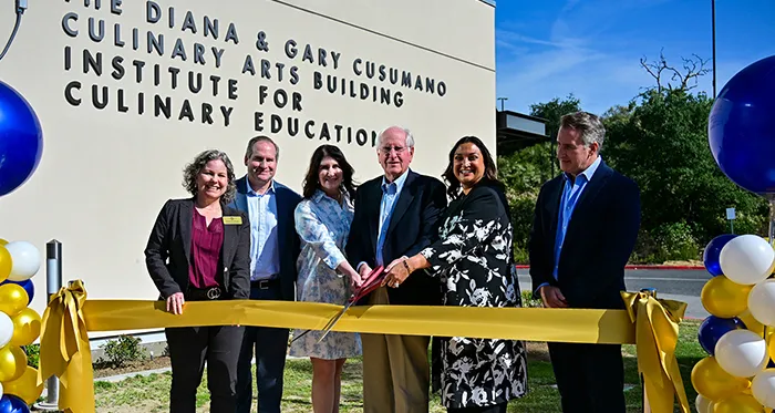 Gary Cusumano (center) is joined by family members and college officials for the ribbon-cutting ceremony for the Diana and Gary Cusumano Culinary Arts Building on Thursday, April 16, 2026.