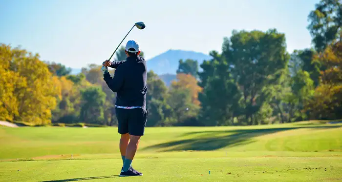 A lone golfer makes a drive during the 2025 golf tournament.