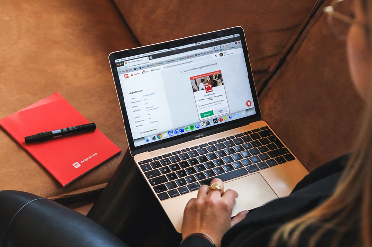 Woman on computer seeking a job.