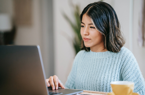 Student on laptop typing Resume & Cover letters.
