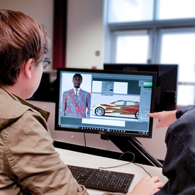 Student on computer with instructor.