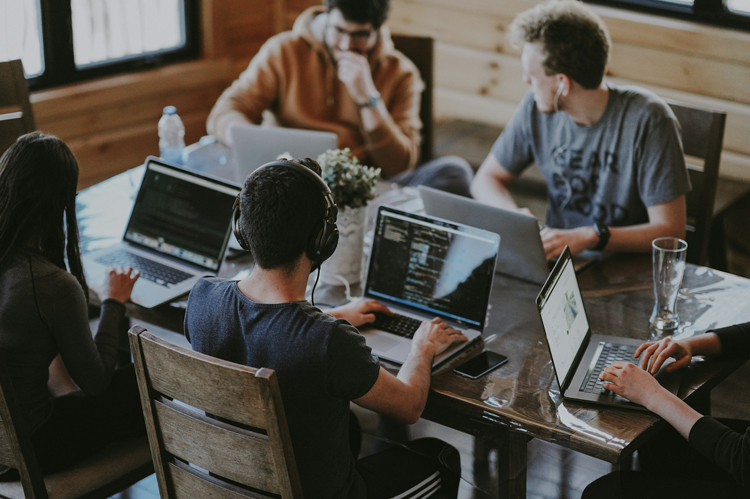 Students at a table with laptops.