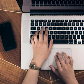Student's hands on a computer keyboard.