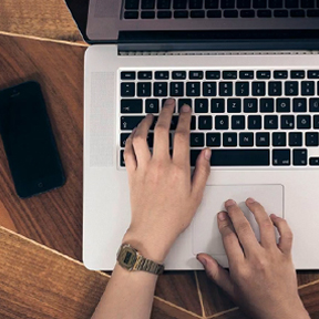 Student's hands on a computer keyboard.
