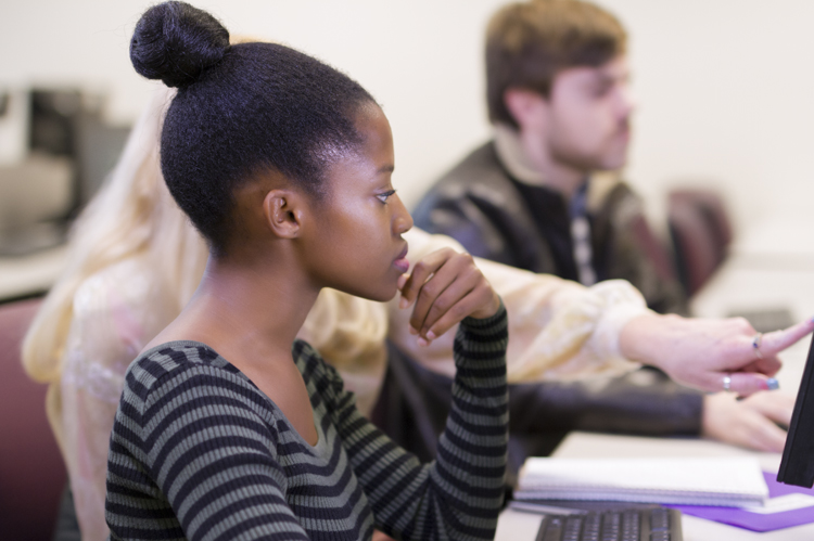 CAWT students with instructor on computers.