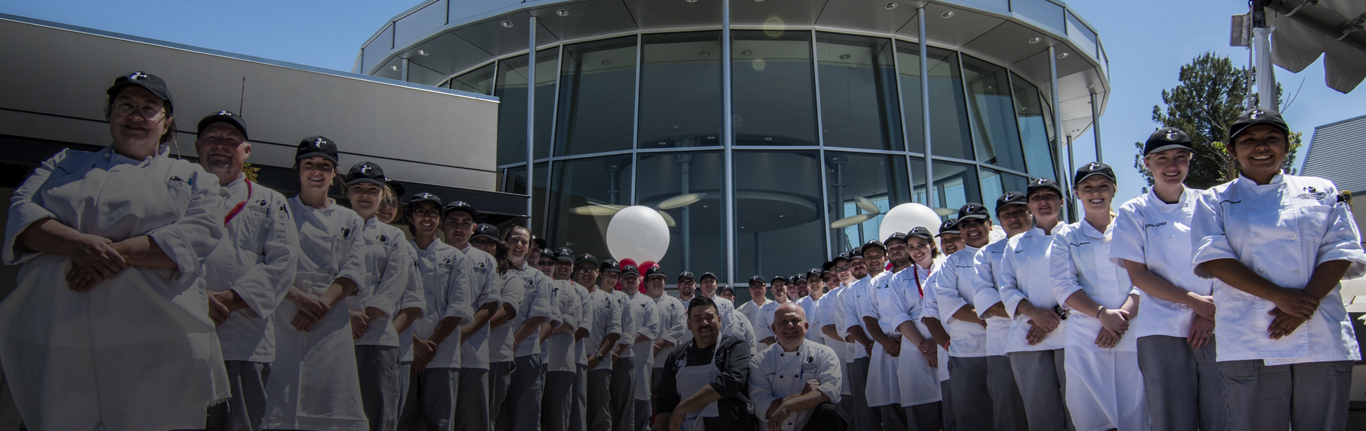 Two rows of iCUE culinary students, with faculty.
