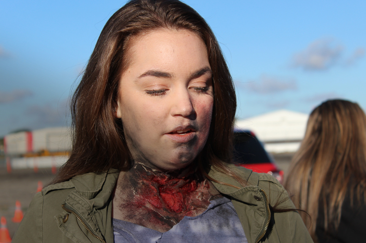 COC EMT student with neck wound moulage.