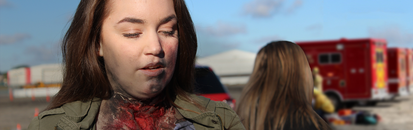 COC EMT student with neck wound moulage.